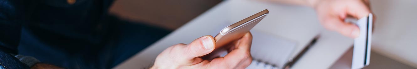 man holding phone and credit card